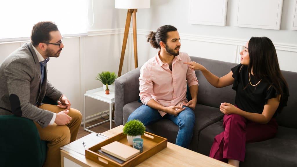 Married couple arguing at couples therapy